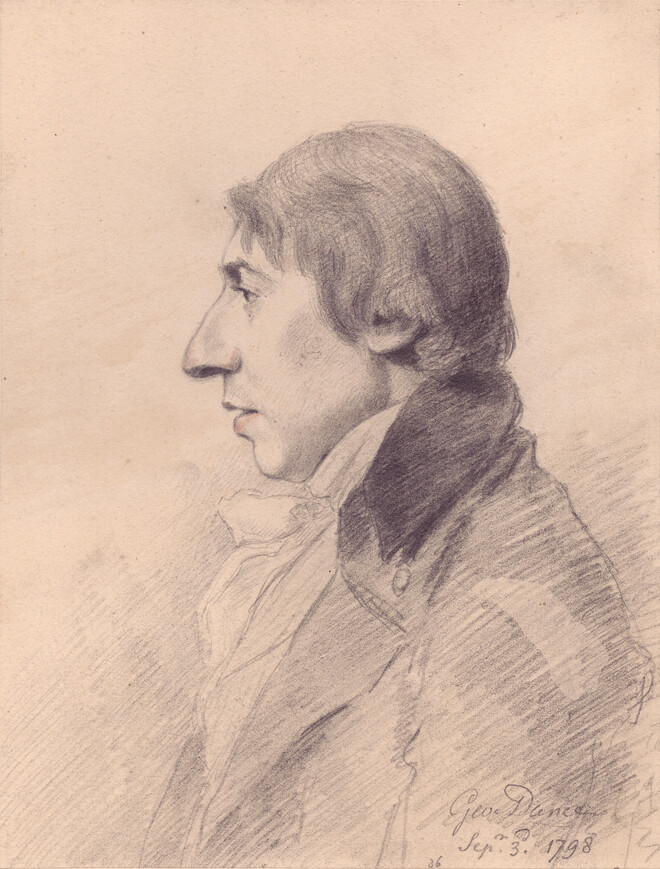 John Deare sat on a rock with his legs crossed, in front of trees, with his top hat next to him